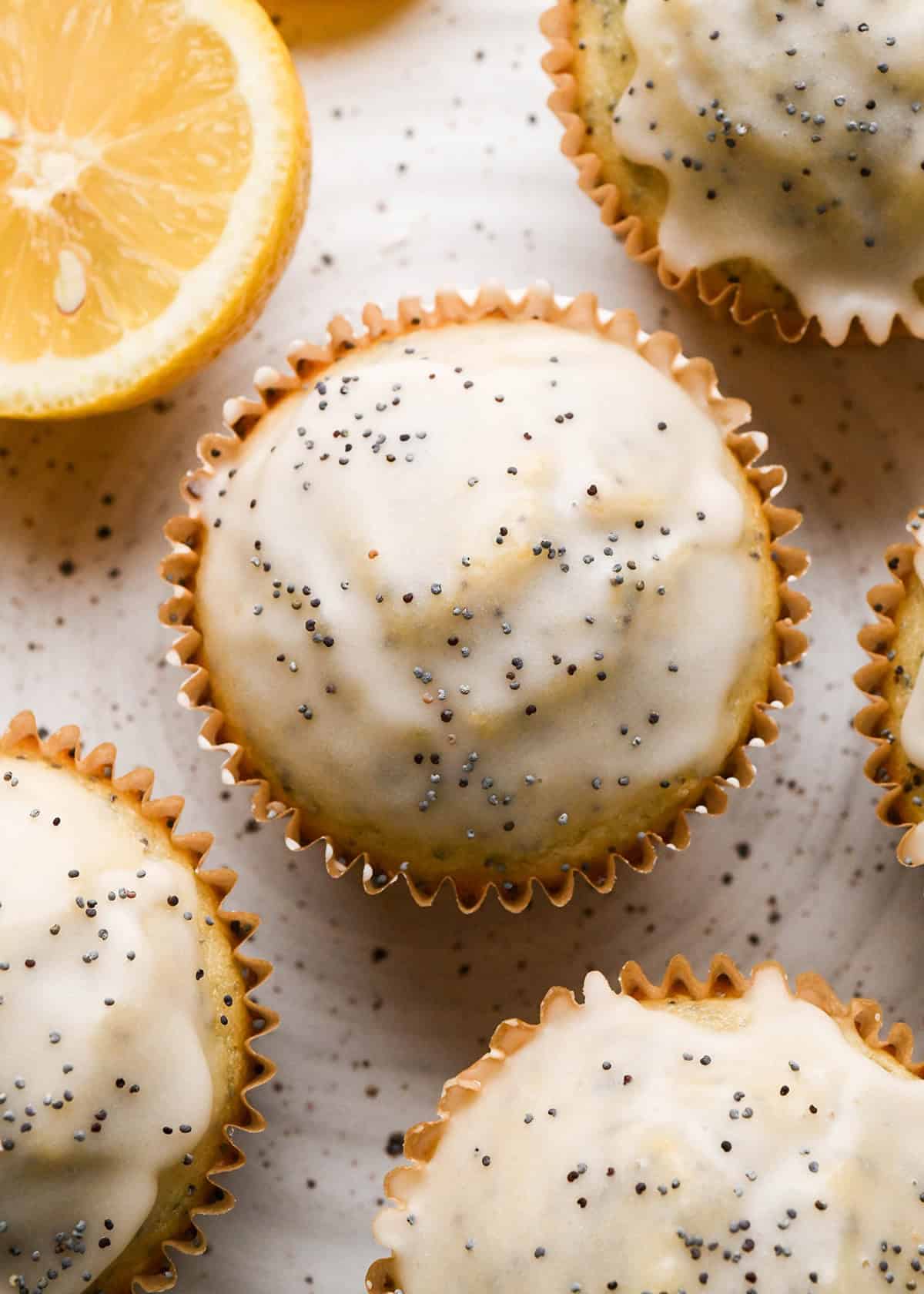 4 Lemon Poppy Seed Muffins on a plate with glaze