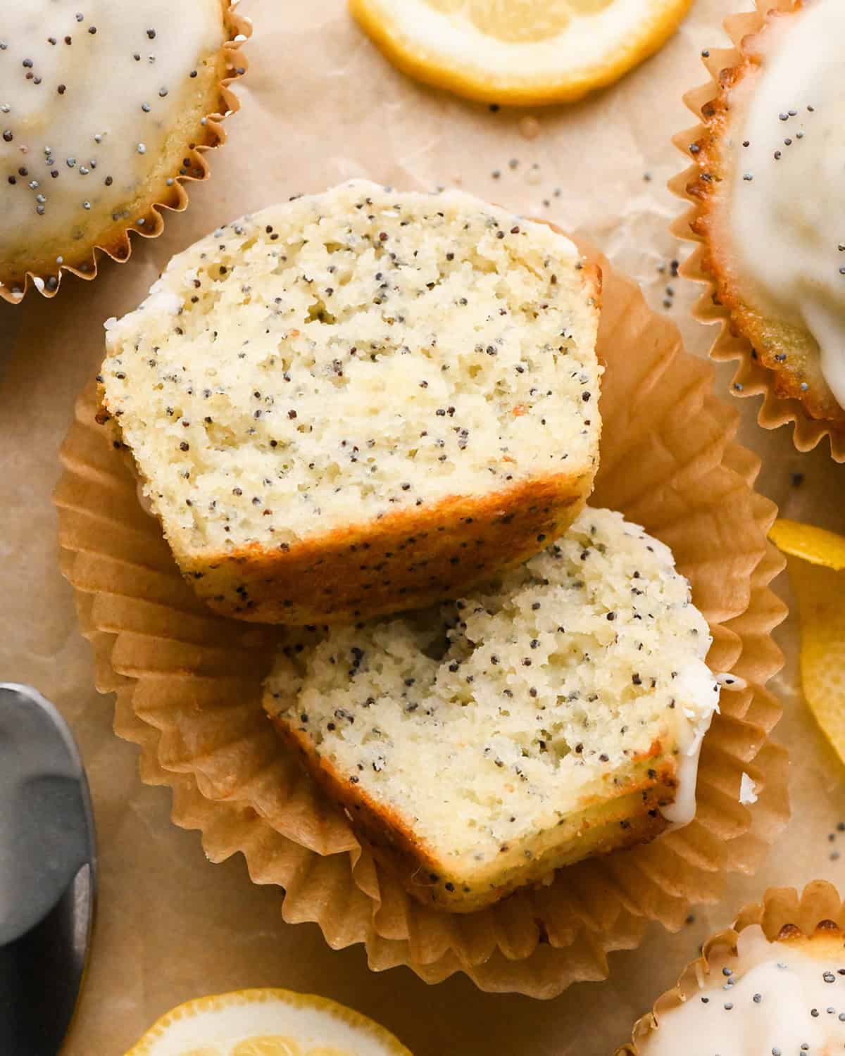 a Lemon Poppy Seed Muffin cut in half on a cupcake liner