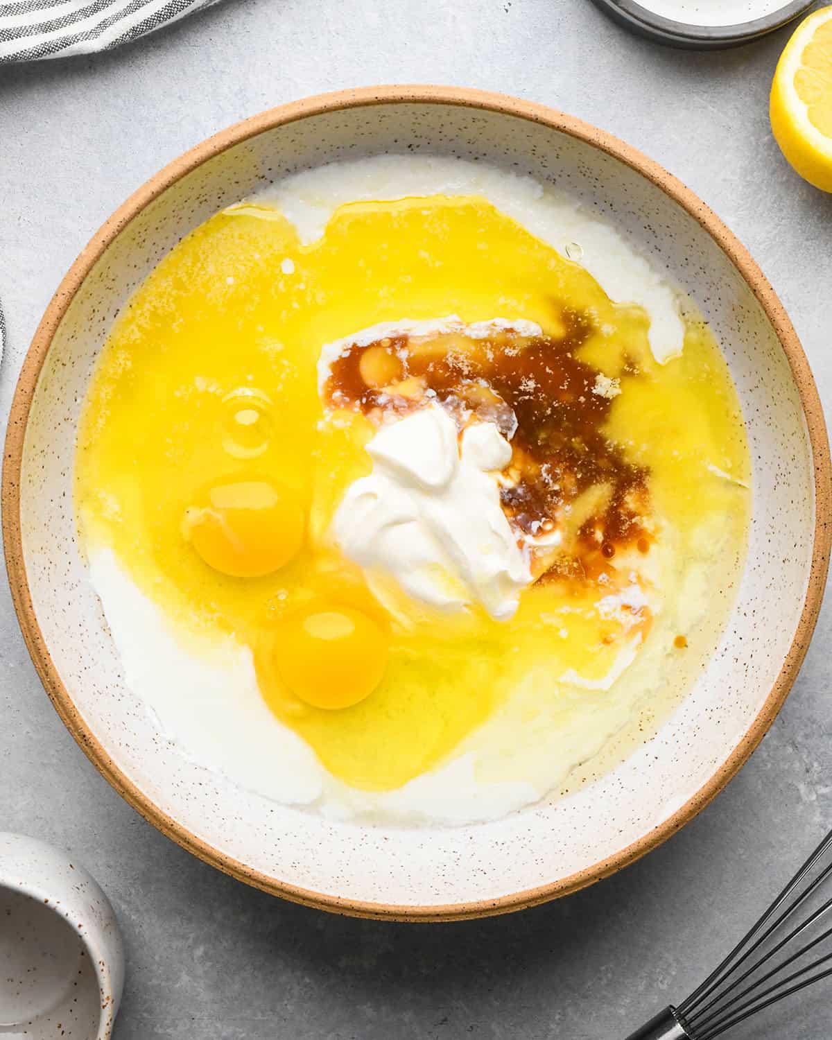 making Lemon Poppy Seed Muffins - wet ingredients in a bowl before whisking