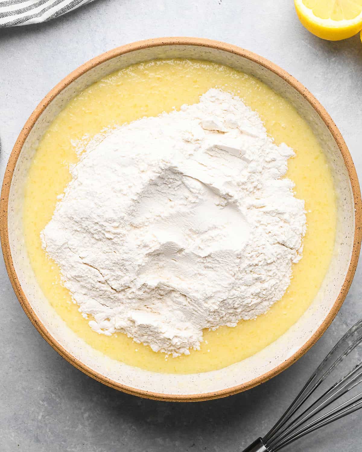 how to make Lemon Poppy Seed Muffins - adding dry ingredients to wet ingredients before whisking it in