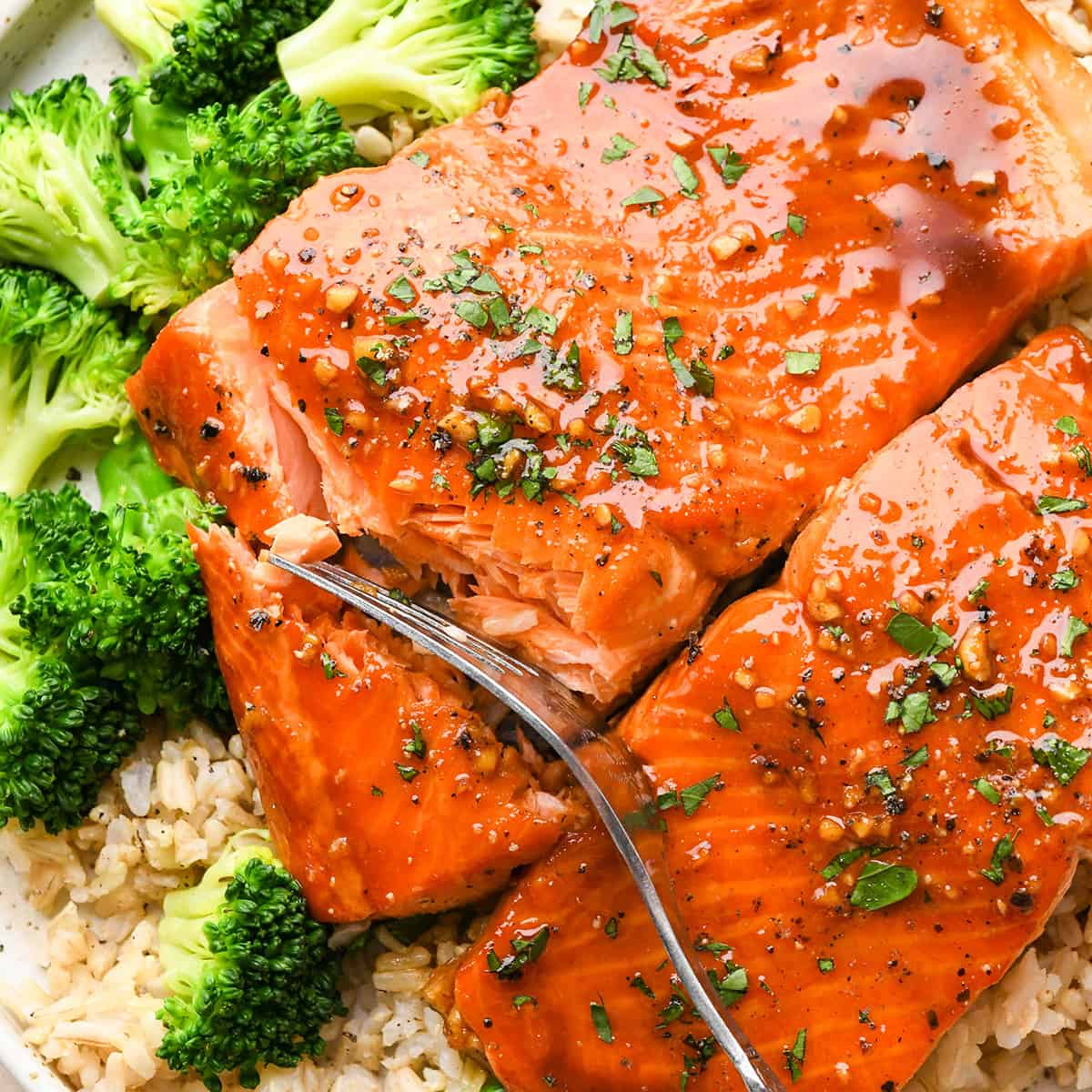 a fork taking a bite of maple glazed salmon