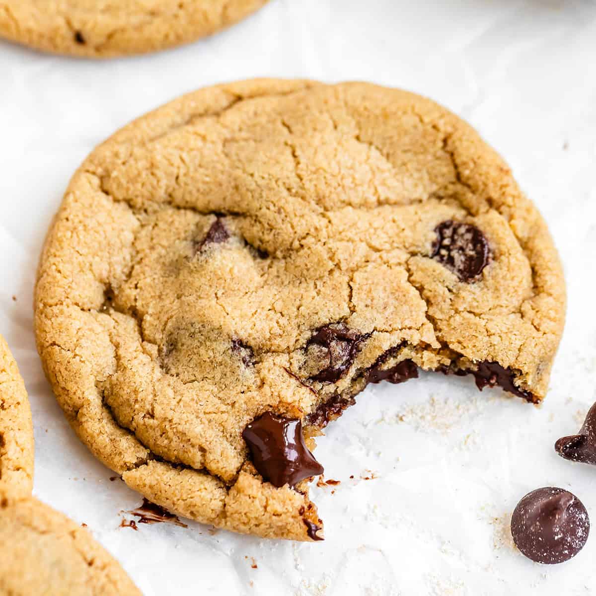 one Oat Flour Chocolate Chip Cookie with a bite taken out of it