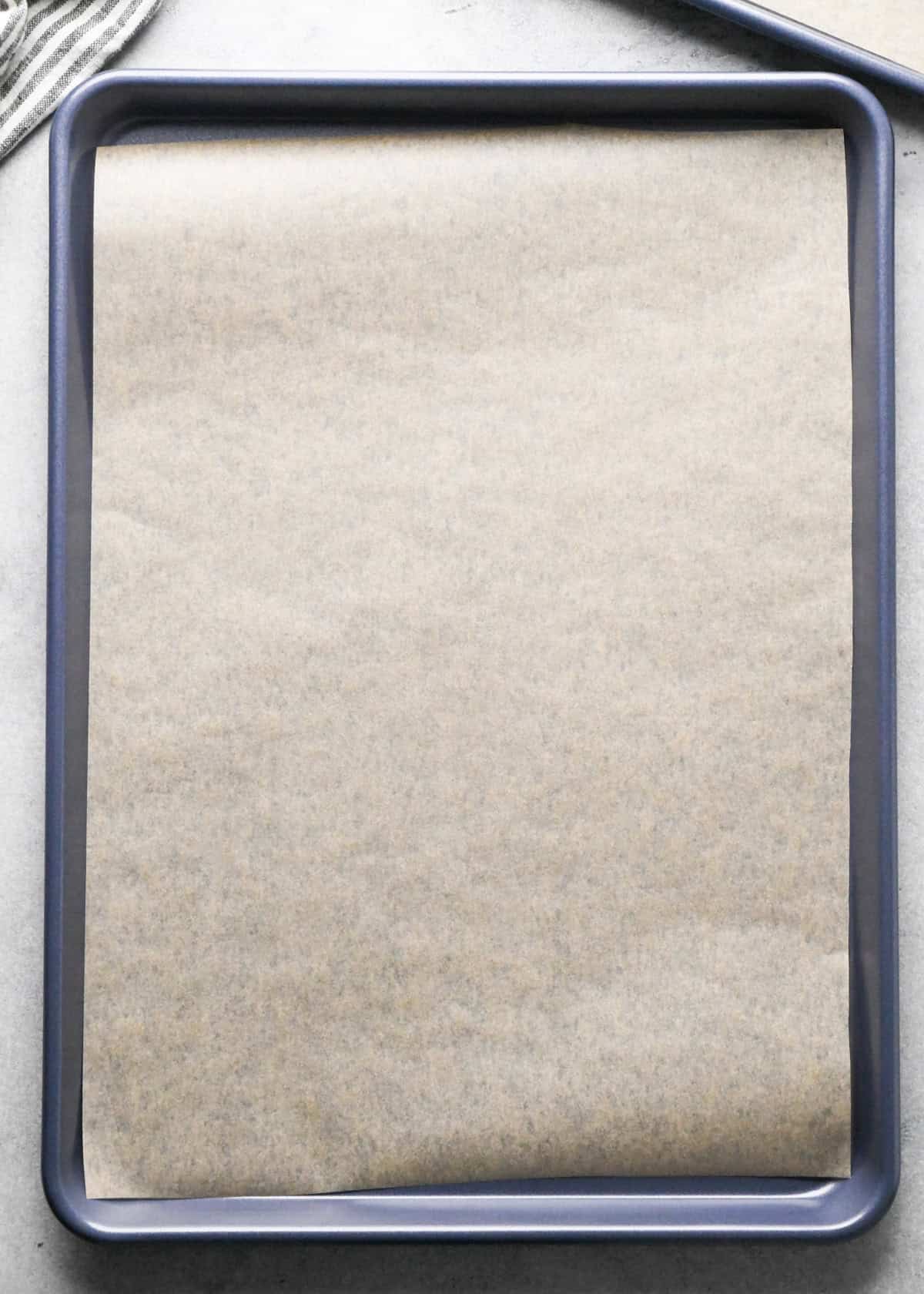 a baking sheet lined with parchment paper making Oatmeal Chocolate Chip Cookies