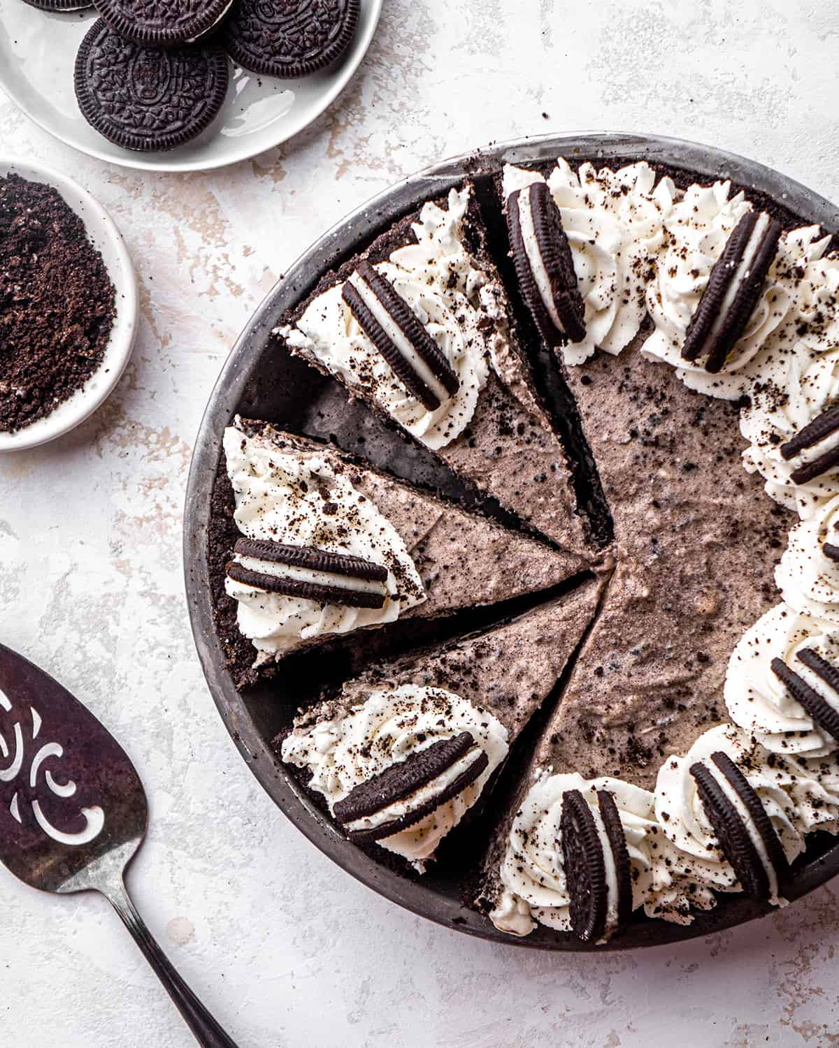 overhead view of an Oreo Pie in a pie dish with 3 slices cut.