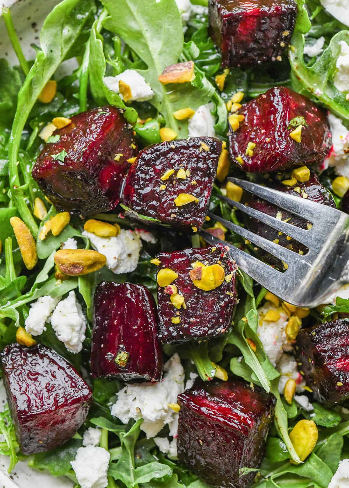 Made with 5 ingredients including fresh beets, this easy Balsamic Roasted Beets recipe is a great side dish or addition to your favorite salad! They are gluten-free, dairy-free, Paleo and vegan-friendly! #beets #roastedbeets #sidedish #roastedvegetables roasted beets on a salad with a fork