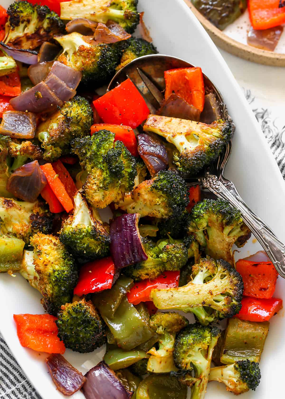 The best oven roasted vegetables recipe! Your favorite veggies are tossed in olive oil and a delicious spice mixture and are roasted until they are perfectly tender and slightly crispy. Baked vegetables are easy to make and a great way to meal prep vegetables for the week. overhead photo of Roasted Vegetables on a platter