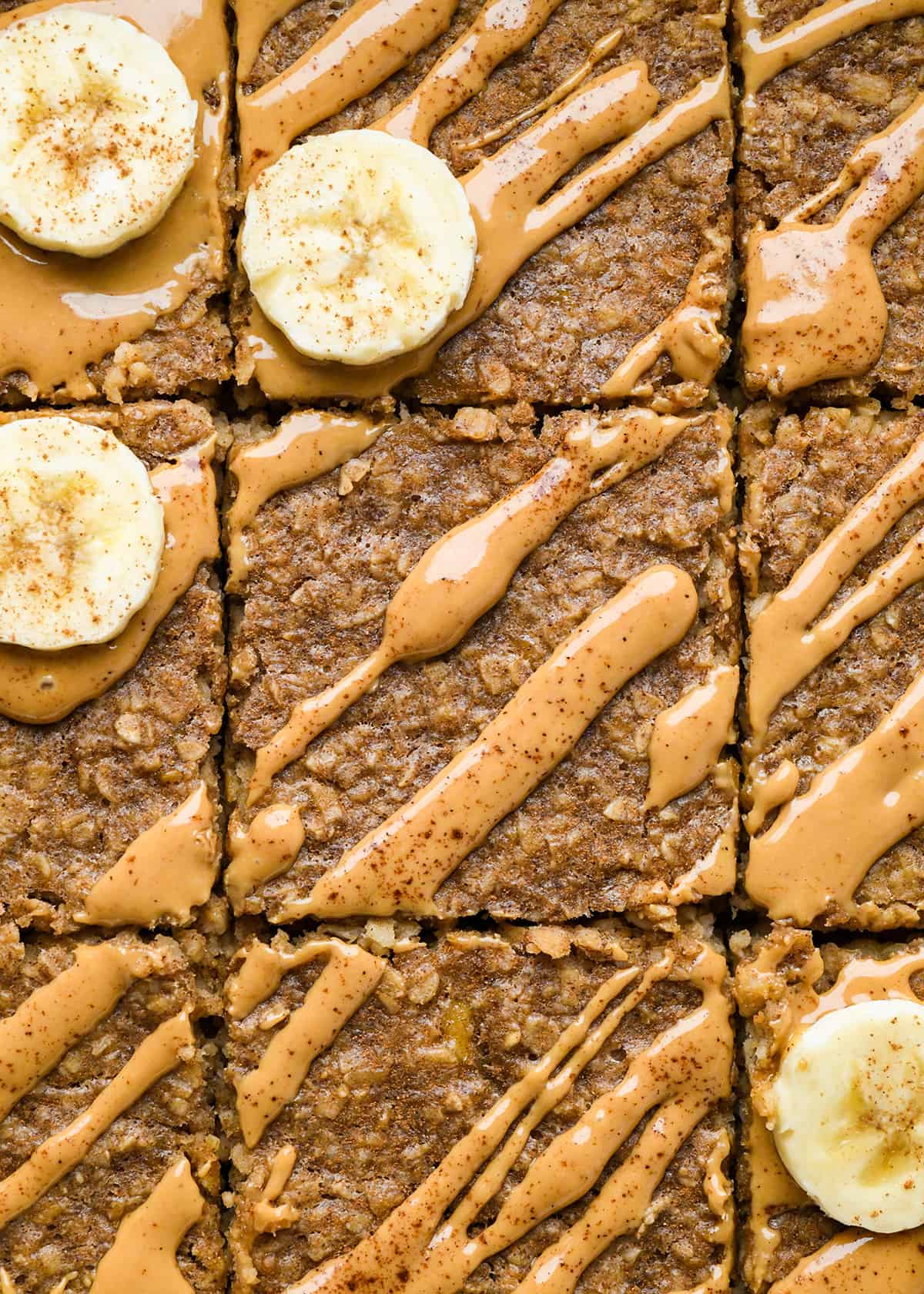 Peanut Butter Banana Baked Oatmeal in a baking dish cut into 9 pieces