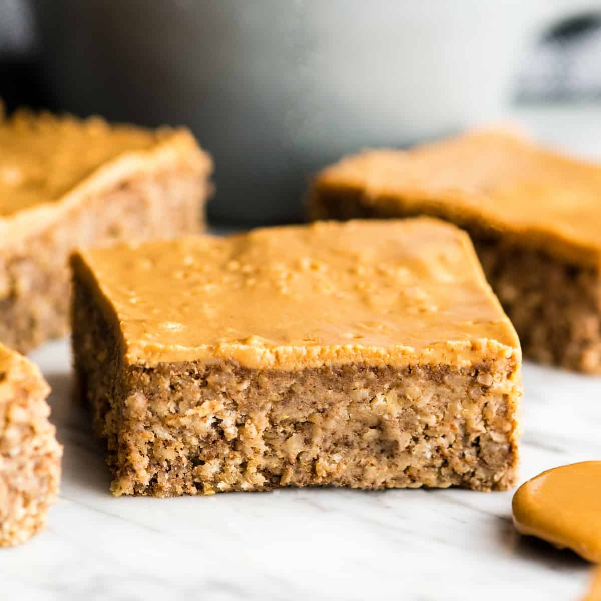 These are the BEST Healthy Breakfast Bars ever! I have eaten one every day for over a decade (seriously)! This easy recipe is made in one bowl in 30 minutes, and is loaded with fiber, protein & omega-3s to keep you full all morning long! Plus they’re gluten-free, dairy-free, refined sugar free and vegan! #breakfastbars #oatmeal #peanutbutter #glutenfree #dairyfree #vegan #healthy #refinedsugarfree front view of a healthy breakfast bar