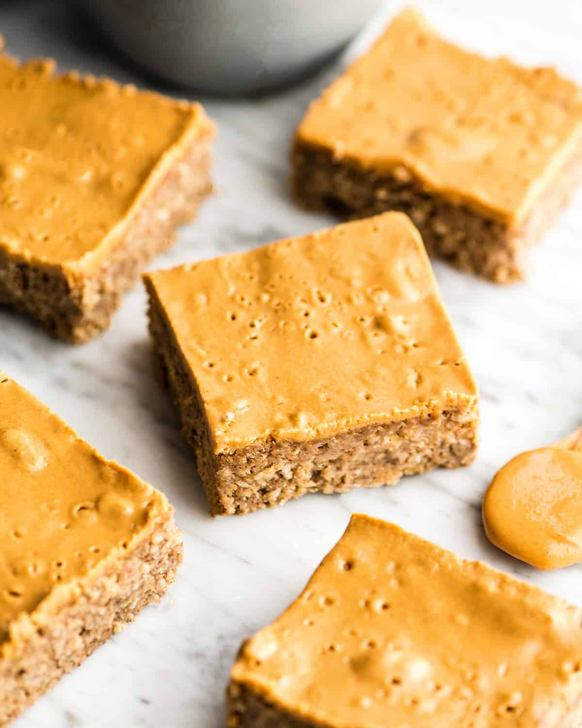 These are the BEST Healthy Breakfast Bars ever! I have eaten one every day for over a decade (seriously)! This easy recipe is made in one bowl in 30 minutes, and is loaded with fiber, protein & omega-3s to keep you full all morning long! Plus they’re gluten-free, dairy-free, refined sugar free and vegan! #breakfastbars #oatmeal #peanutbutter #glutenfree #dairyfree #vegan #healthy #refinedsugarfree Overhead view of five healthy breakfast bars cut into squares