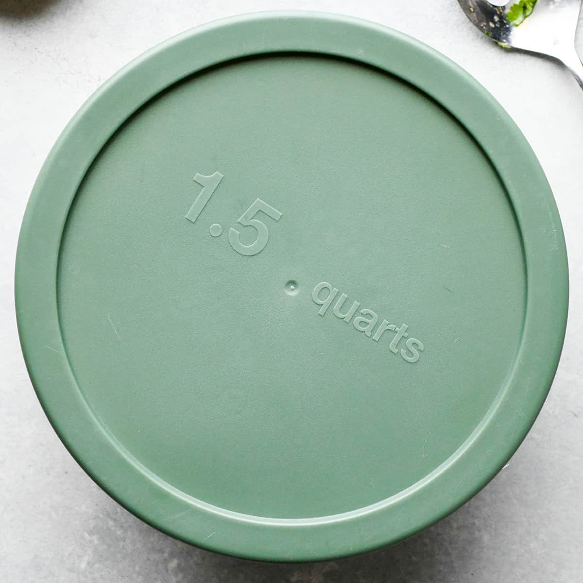 Pineapple Salsa in a glass mixing bowl with a lid to be chilled