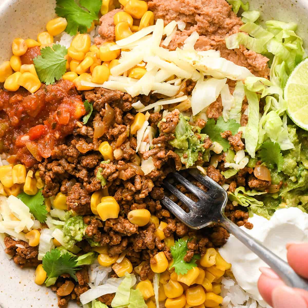 up close photo of a fork taking a bite of Taco Bowls