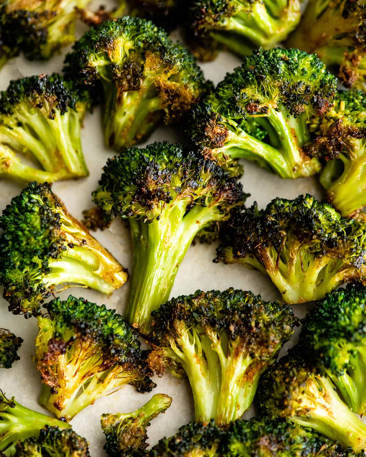 This is the best oven-roasted broccoli recipe! This easy roasted broccoli is made with 6 ingredients in 15 minutes! It's crispy, tender and perfectly seasoned! Baked broccoli is a healthy side dish that pairs well with everything! #broccoli #broccolirecipes #healthysidedish #sidedish #roastedbroccoli #joyfoodsunshine overhead view of roasted broccoli