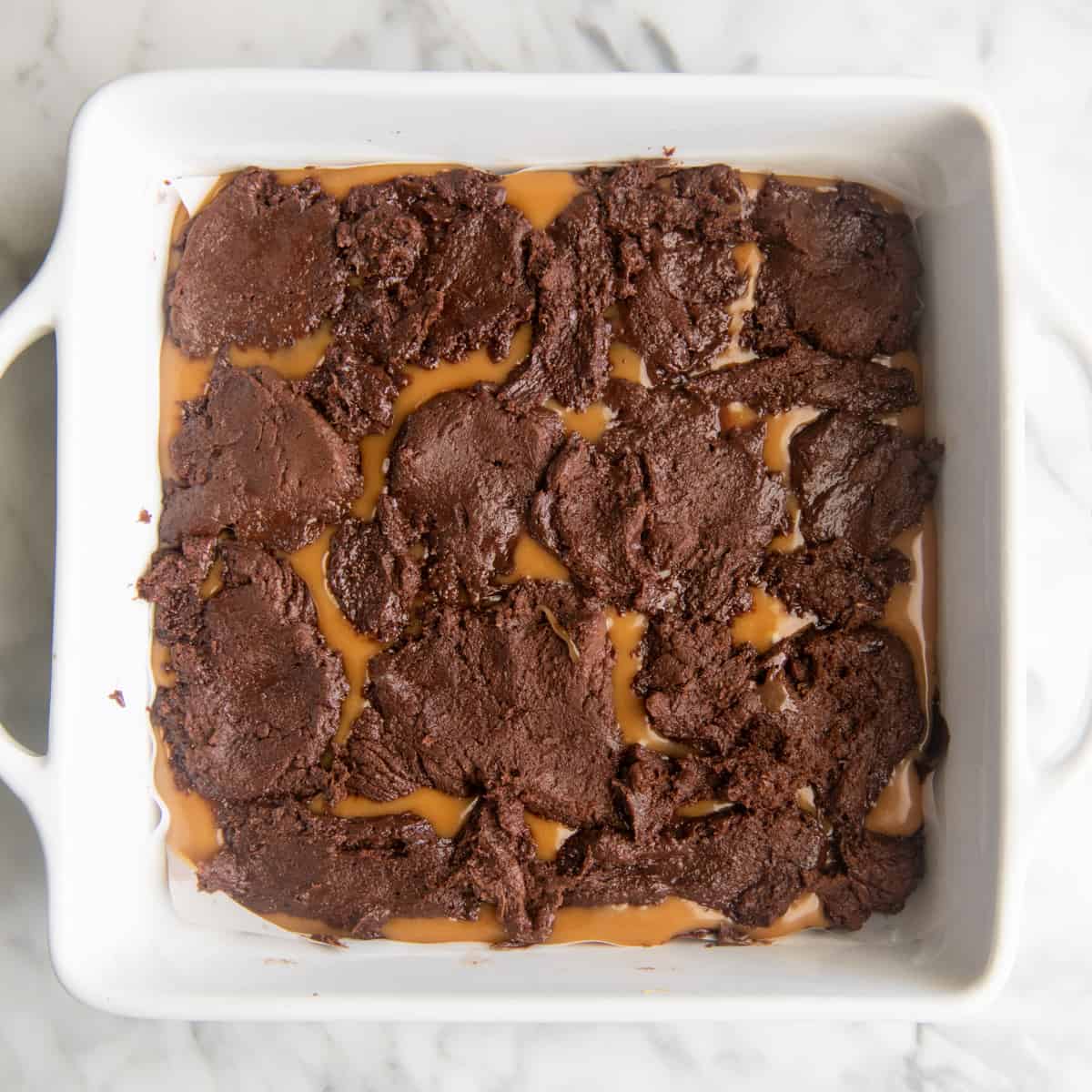 caramel brownies in a baking dish before baking