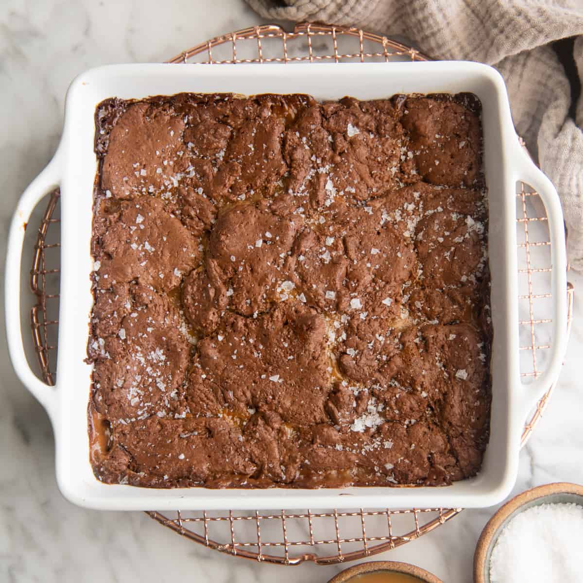 caramel brownies in a baking dish after baking with sea salt on top