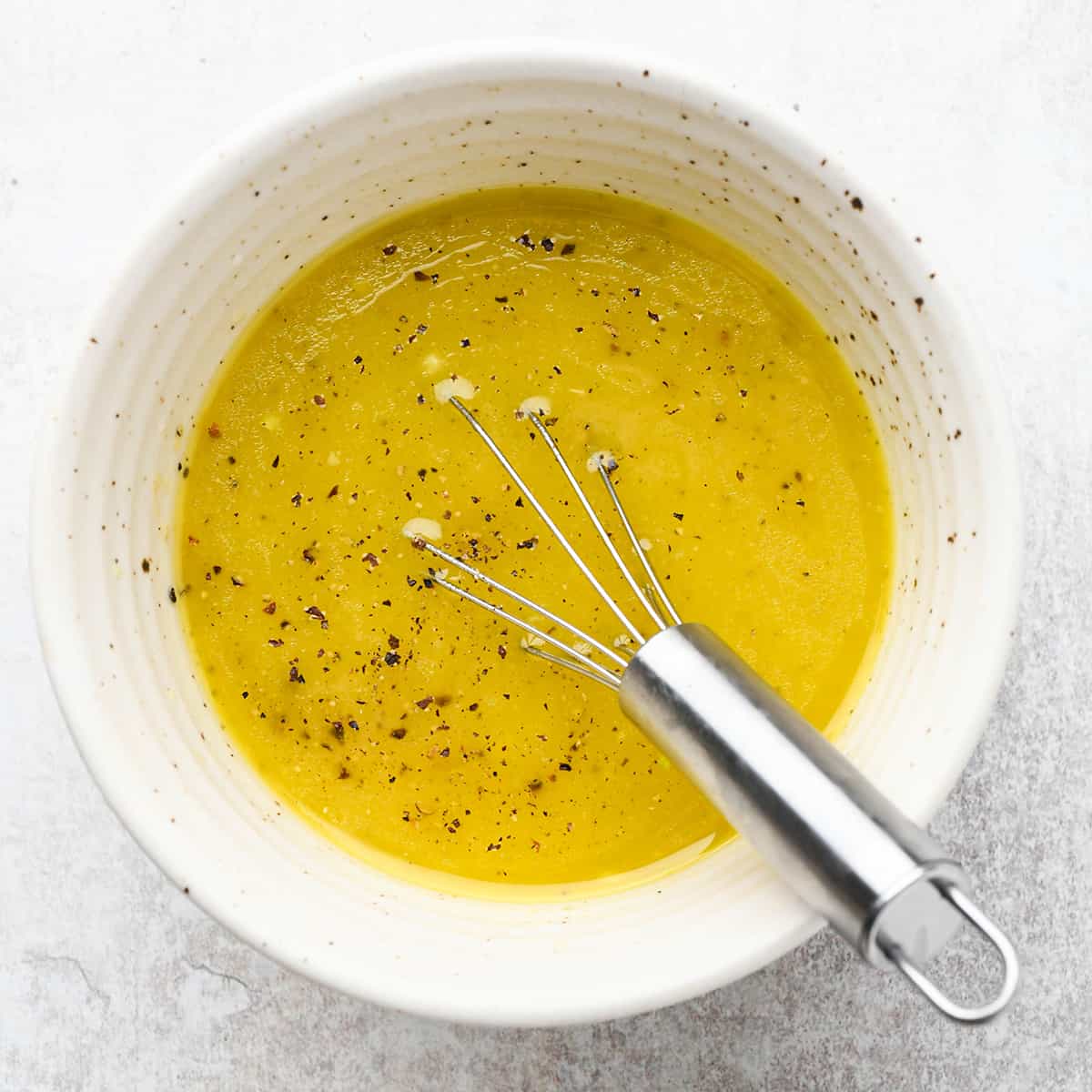 whisking the lemon dressing ingredients for this summer pasta salad