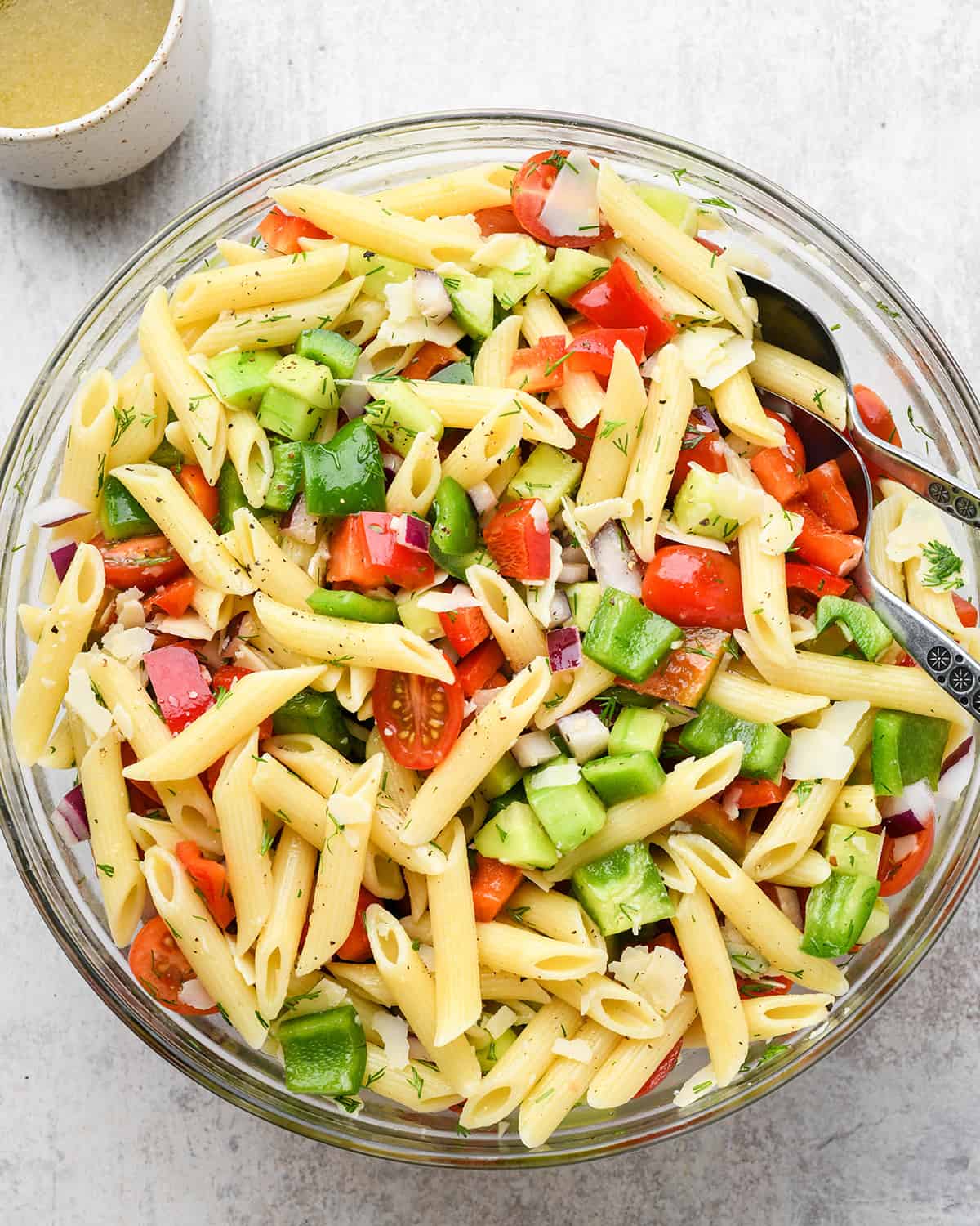 lemon pasta salad being stirred together in a large bowl