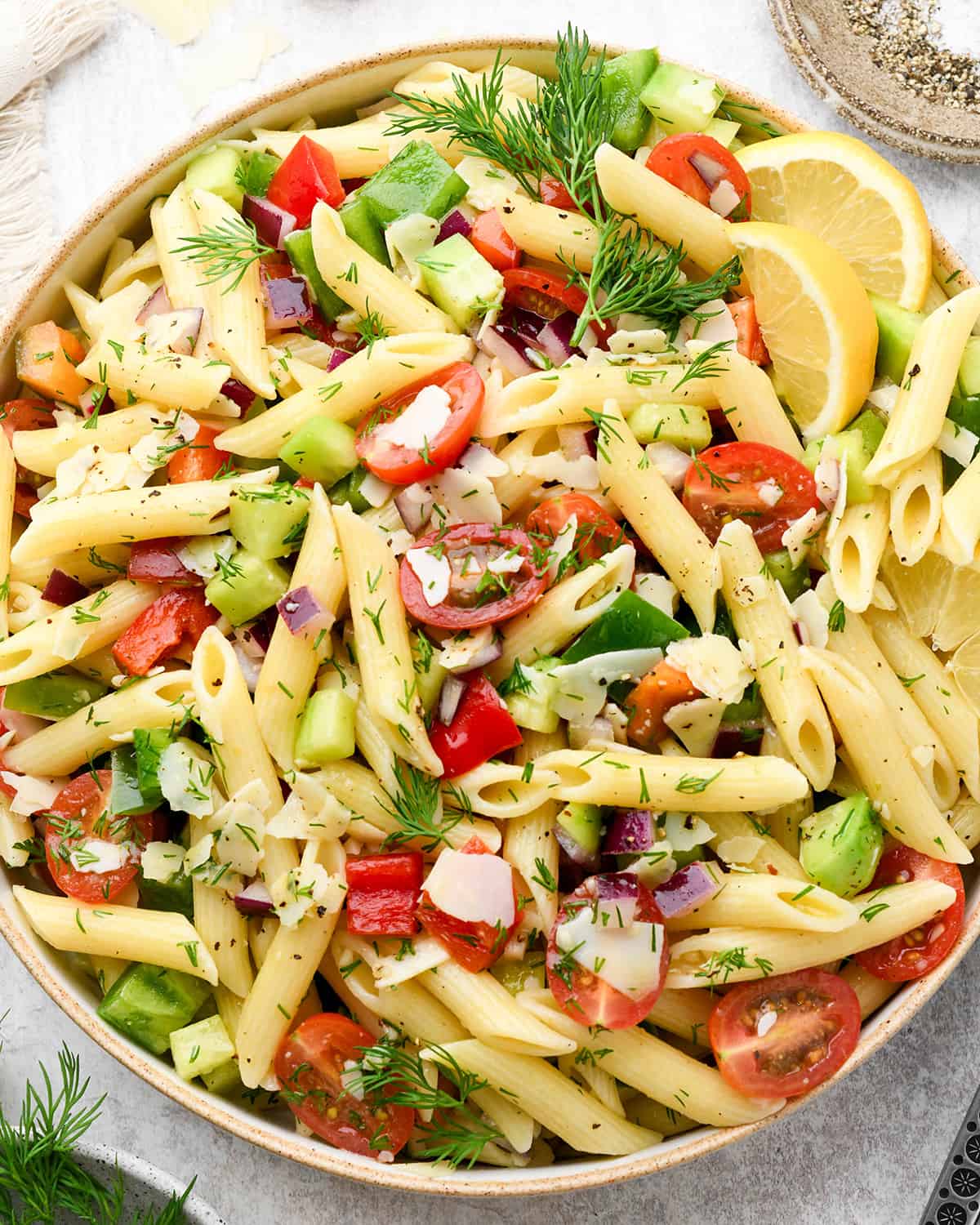 Lemon Summer Pasta Salad in a large serving bowl garnished with dill