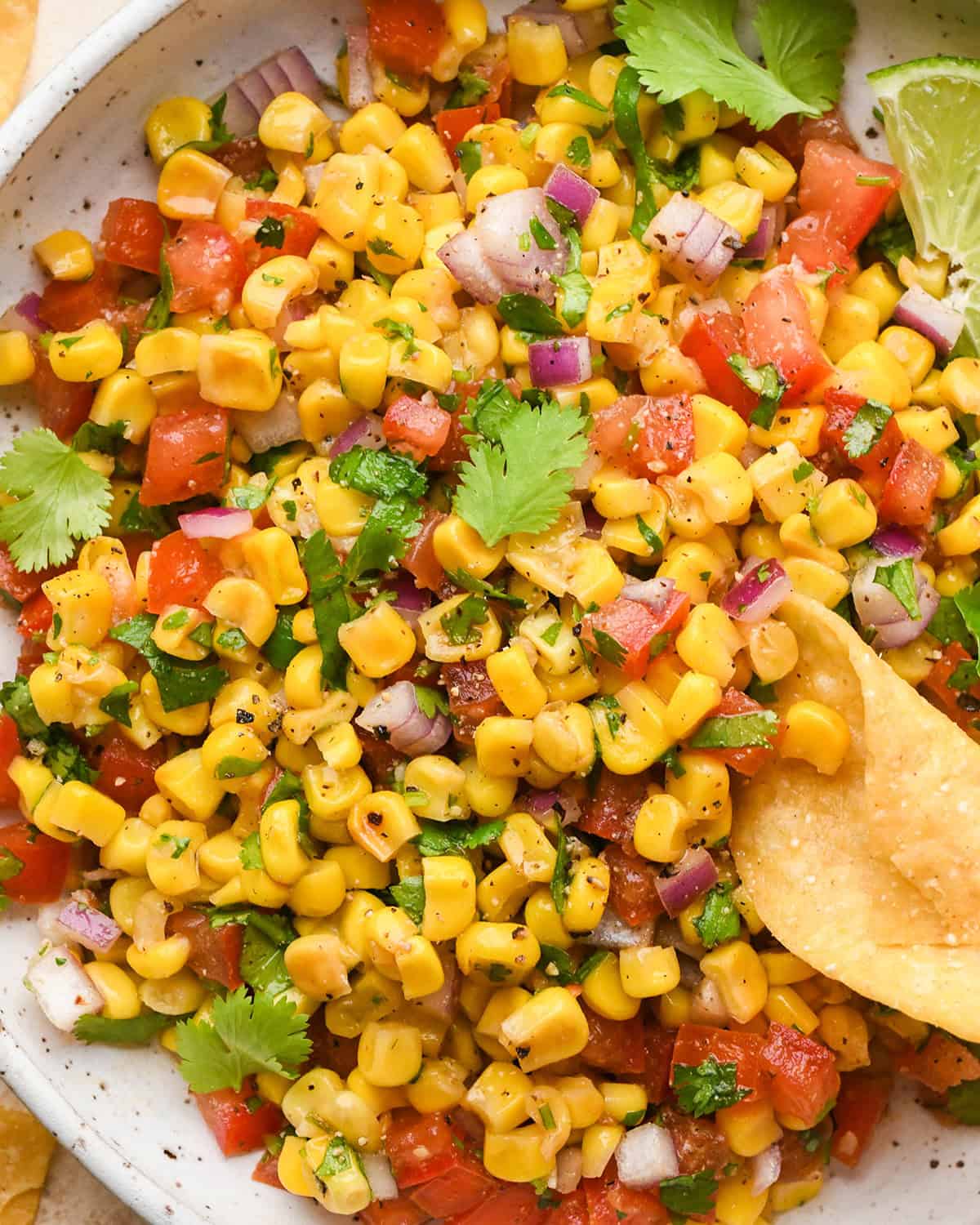 sweet corn Salsa in a bowl with a chip