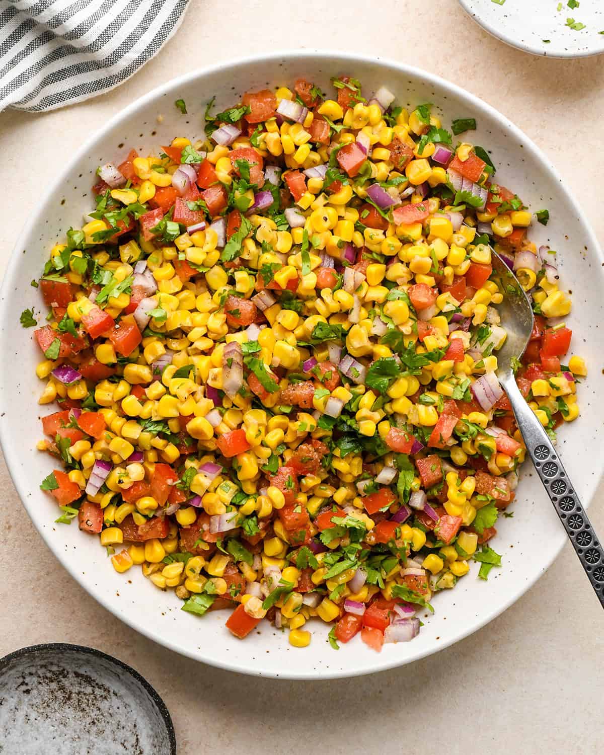assembling corn salsa- ingredients mixed in a bowl