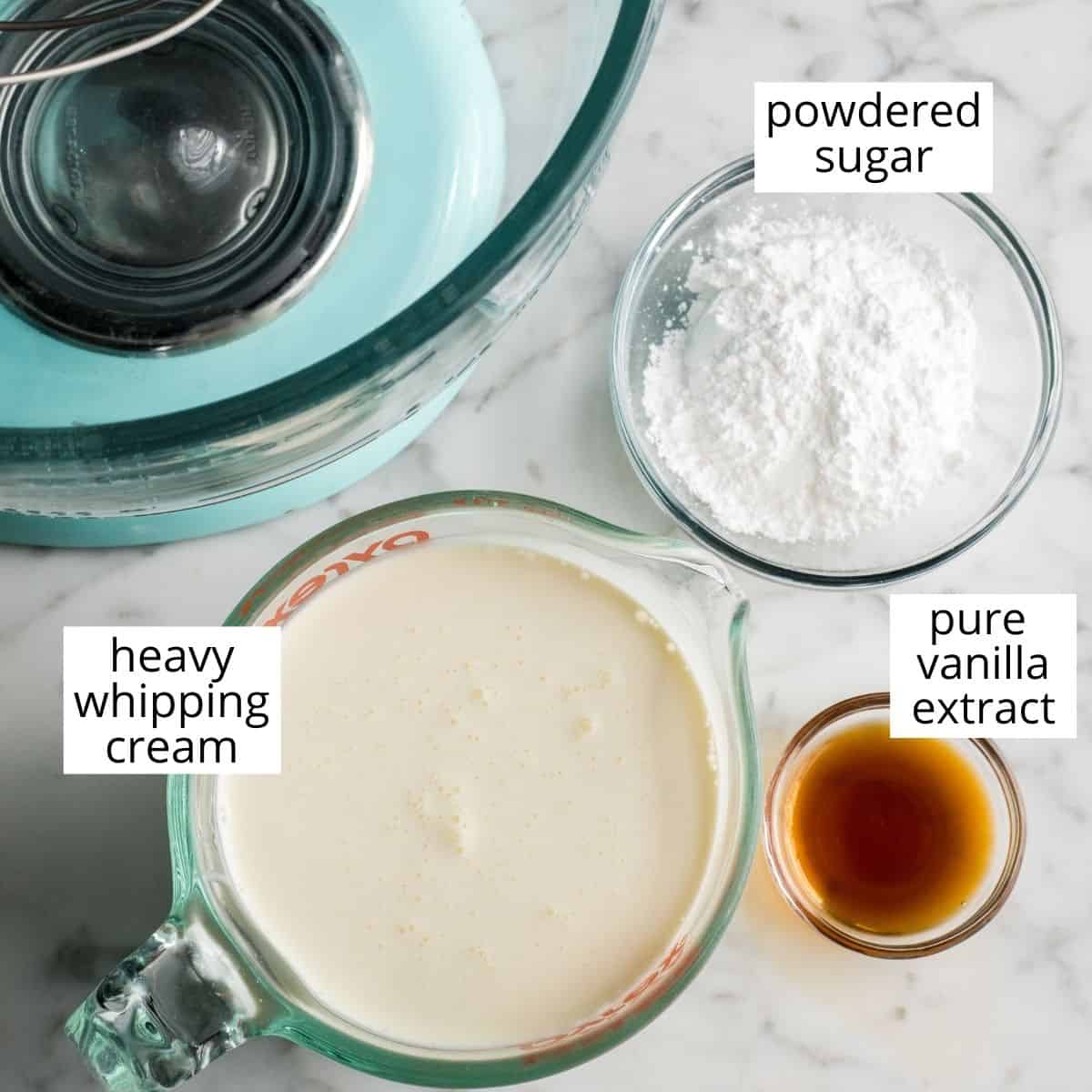 Homemade whipped cream is easy to make with only 3 ingredients in 5 minutes and it's so delicious you'll ditch the store-bought stuff for good once you try it! Watch the video and follow our step-by-step photos to learn how to make the best homemade whipped cream recipe! #whippedcream #heavycream #homeamdewhippedcream #joyfoodsunshine #whippedcreamrecipe overhead view of the ingredients in this homemade whipped cream recipe