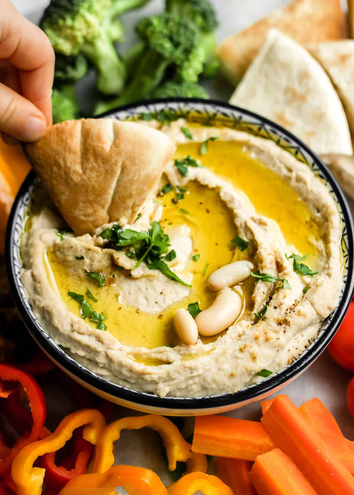 pita bread being dipped into White Bean Hummus