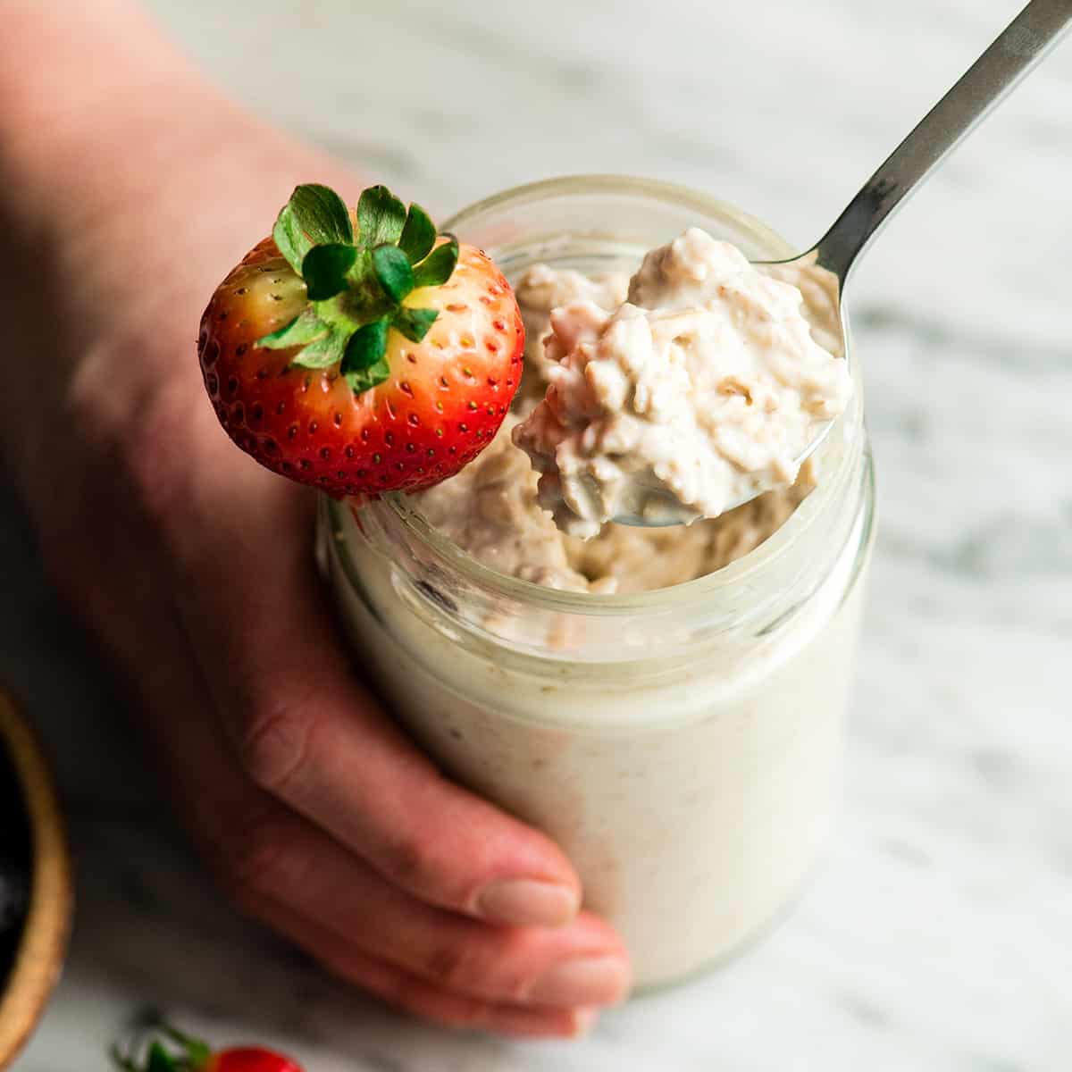 Easy Overnight Oats with Yogurt are a great healthy high-protein breakfast! This recipe only takes 6 ingredients and 5 minutes to prepare! Plus it's no-cook, gluten-free and can easily be made dairy-free! #overnightoats #oatmeal #greekyogurt #yogurt #glutenfree #breakfast #healthyrecipe #mealprep Overhead view of a jar of yogurt overnight oats